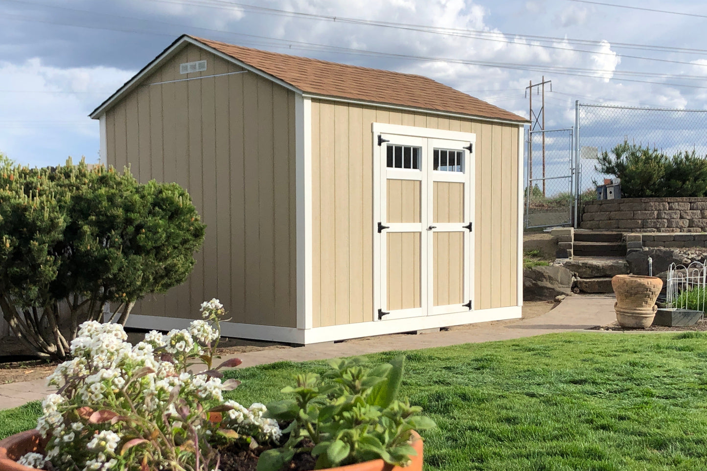 Wooden shed with a white door in a backyard setting